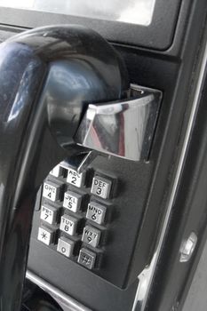 Black public telephone closeup