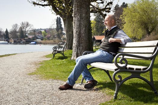 An old man is relaxing in the sun