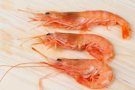 Fresh prawns or shirmps on a wooden board