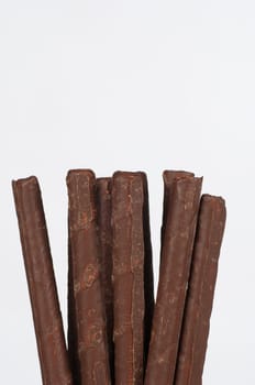 Cunchy sweet rolled chocolate wafers on white