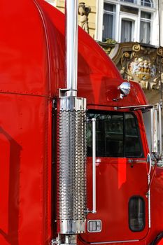 part of big red truck cabin on the road