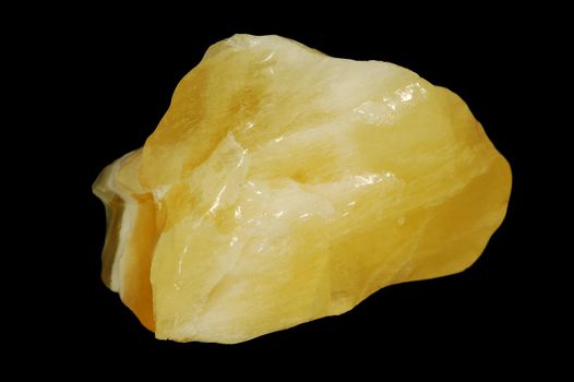 Yellow mineral calcite on black background.