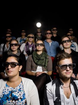 People at the movie Theater wearing 3d glasses