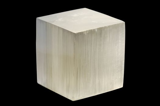 White selenite cube on black background.