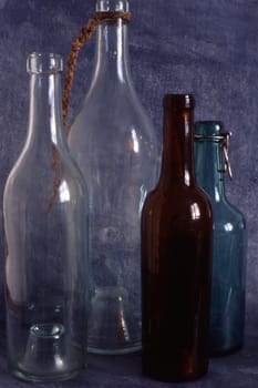Empty bottles isolated on painted background