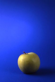 One green apples isolated on blue background