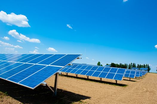 Solar Energy Farm with bright Sky and some Clouds