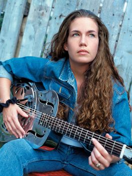 A beautiful country singer thinking about her songwriting.  
