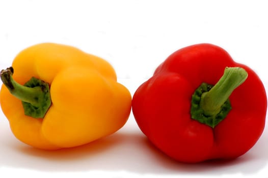 two red and yellow peppers isolated on the white background