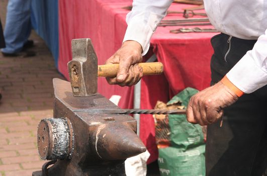Hammer and anvil, blacksmith hammering iron
