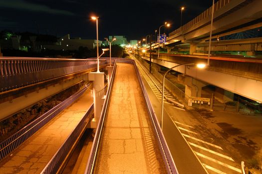 night image of well and high density organized Japanese urban roads area with many highways and slope way for bicycles and pedestrians, Tokyo, Japan