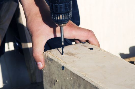 motor driver work. assembling plywood box. close-up.