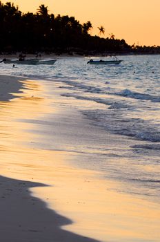Sandy beach of a tropical resort at sunset