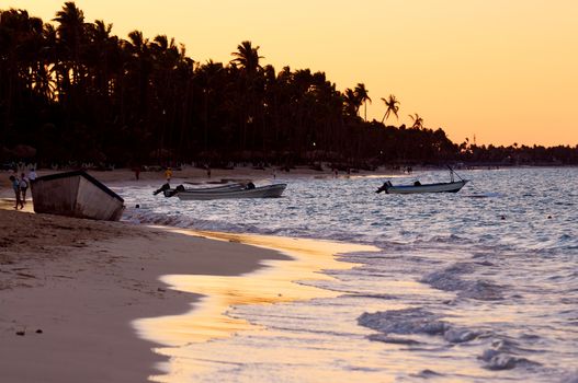 Sandy beach of a tropical resort at sunset