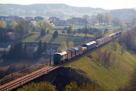 Freight train passing the hilly landscape
