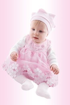 Baby girl in fancy dress over pink background
