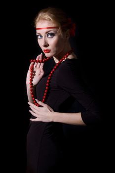 Retro style woman dress and red necklace over black