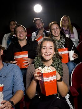 Spectators eating popcorn at the movie theater