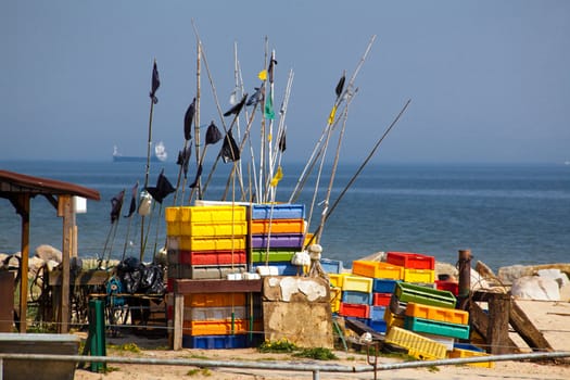 Fishing equipment with color boxes on the beach
