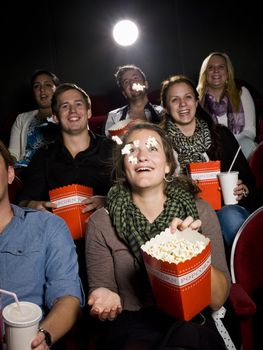 Spectators eating popcorn at the movie theater