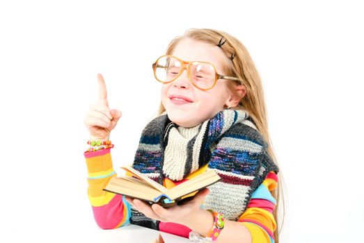 studio shot of pretty little girl reading a book