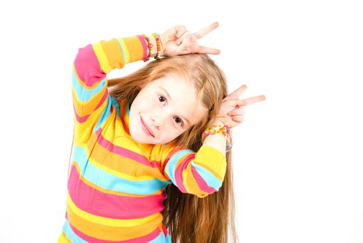 studio shot of pretty little girl with fingers like horns