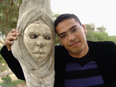 Tunisian man with graved tree showing a human face.