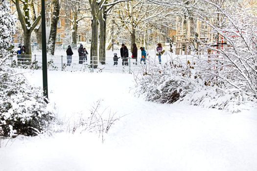 City in the snow - children playing in the park