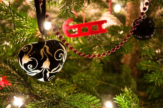 Various Christmas balls hanging from Christmas tee