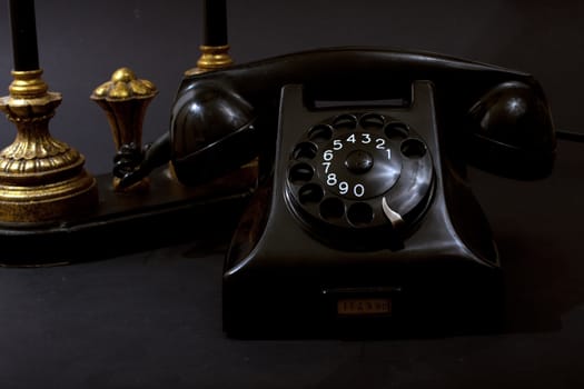 Antique Telephone with lamp on black background