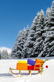 colorful presents on a Santa Claus sledge in a winter landscape