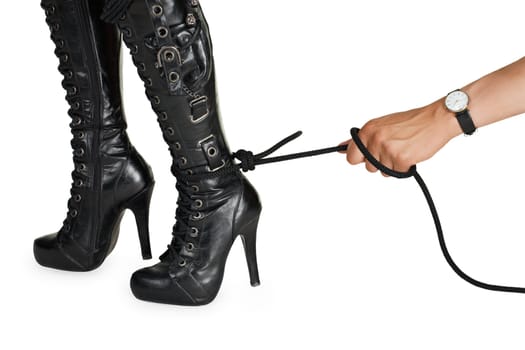 Man's hand pulling a rope tied to a woman's leg