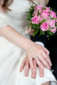 Bride and Groom showing their Rings and her pink Bunch