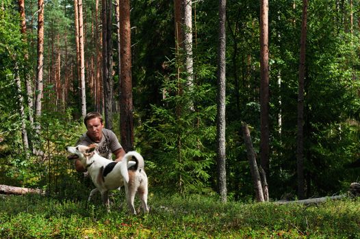 The man in  forest with dog