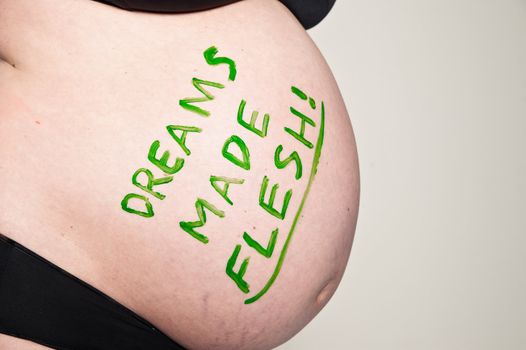 Detail of a Pregnant Stomach with Text on it