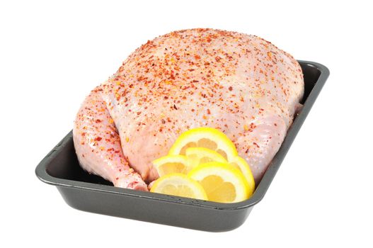 Stuffed chicken  on a baking sheet, decorated with lemon.  Isolated  on white.