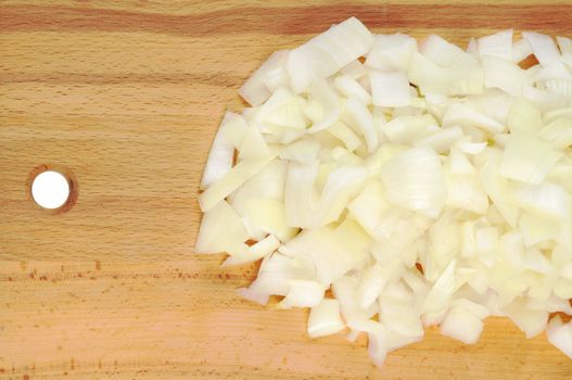 Chopped onions on a wooden board. CloseUp.