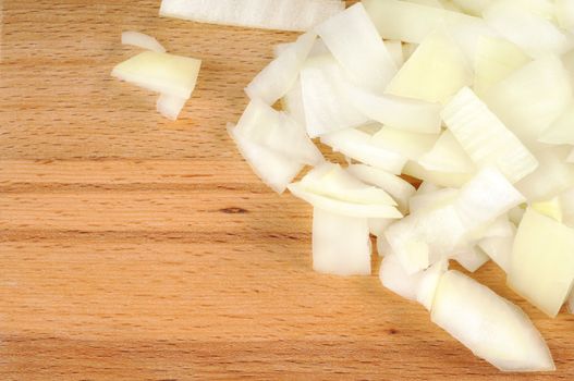 Chopped onions on a wooden board. CloseUp.