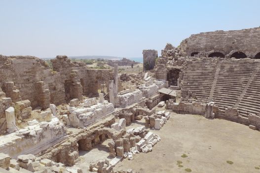 The ruins of the ancient amphitheater. Turkey, Side. Amid the ruins - ancient columns.