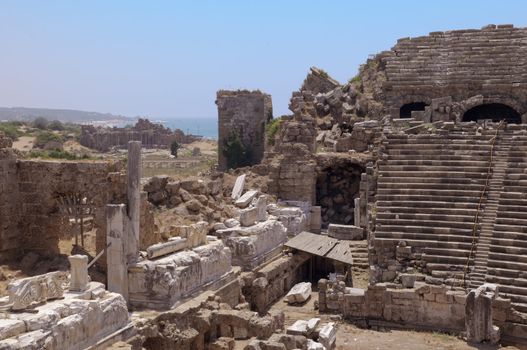 The ruins of the ancient amphitheater. Turkey, Side. Amid the ruins - ancient columns.