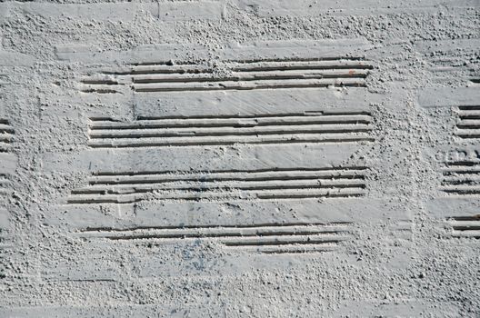 Brick wall painted with a white paint, closeup background.