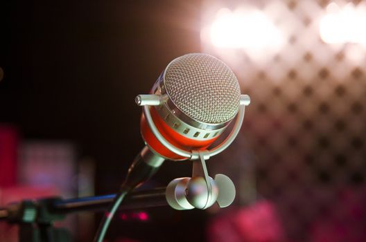 Closeup of audio microphone on stage background