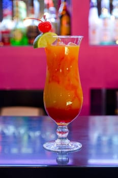 Tropical cocktail in glass on bar counter