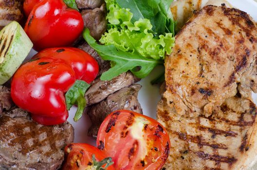 BBQ meat with vegetables and greens closeup