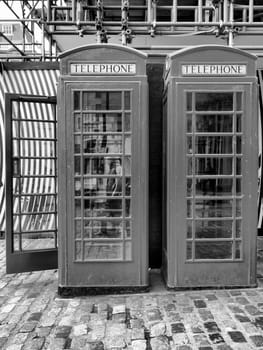 Traditional red telephone box in London, UK - high dynamic range HDR - black and white