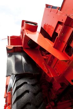 Front and wheel of vinatge giant mining truck. Extreme perspective isolated on white.