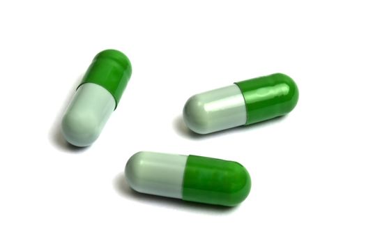 Green capsules isolated on white
