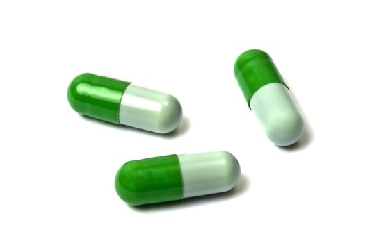 Green capsules isolated on white