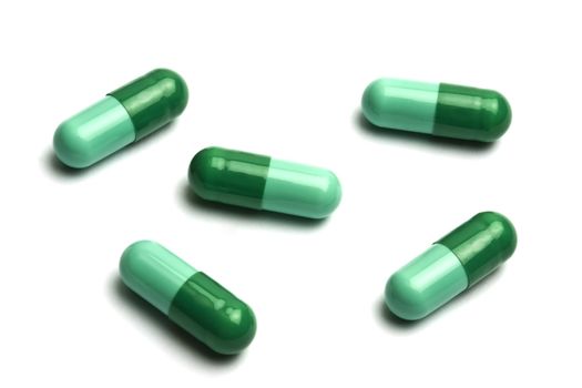 Green pills on white