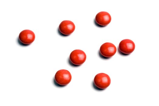 Some red pills isolated on white background